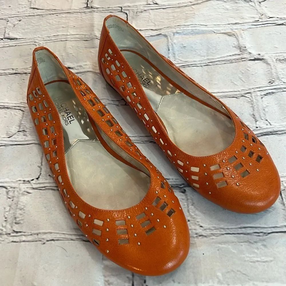 * Michael Kors orange leather flats with square cut outs, and silver studs